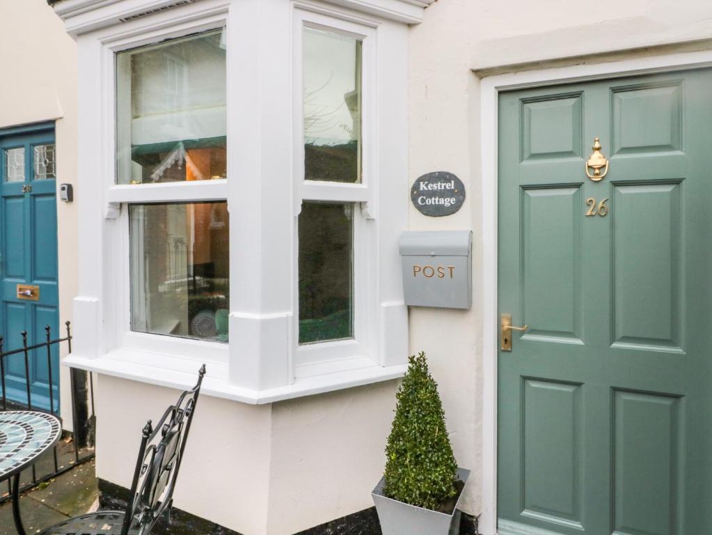 a house with a green door and a christmas tree at Kestrel Cottage in Middlesbrough