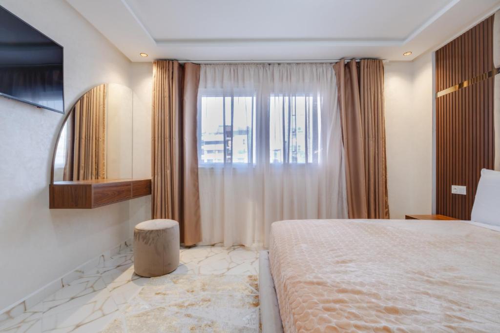 Postel nebo postele na pokoji v ubytování Appart-Hotel IMMOKA