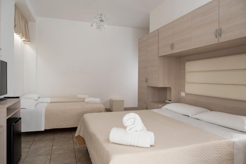 Postel nebo postele na pokoji v ubytování Hotel Leon D'oro