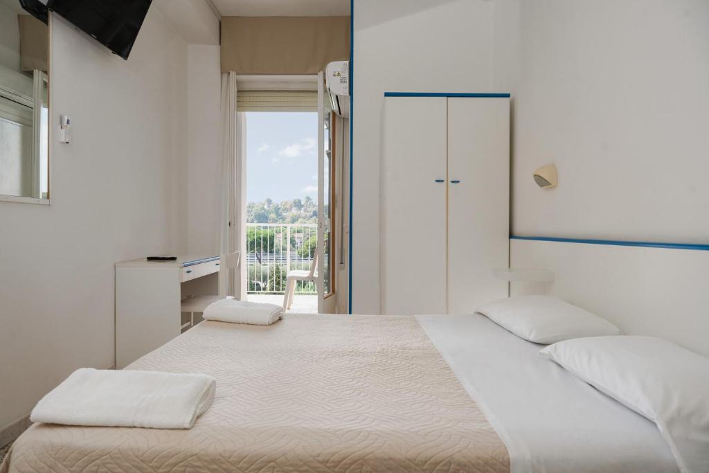 Postel nebo postele na pokoji v ubytování Hotel Leon D'oro