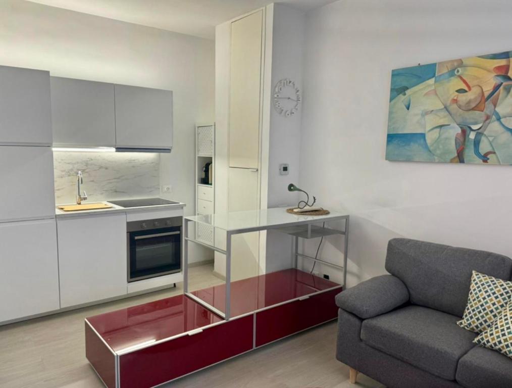 a living room with a couch and a kitchen at Civico 45 in Ancona