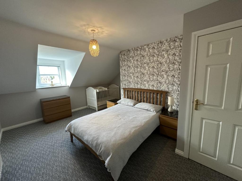 a bedroom with a bed and a window at Distillery House in Bushmills