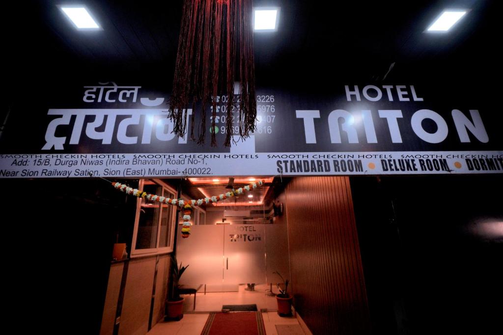 a stage with a sign for a hotel function at Hotel Sion TriTon - Sion Mumbai Hotels in Mumbai