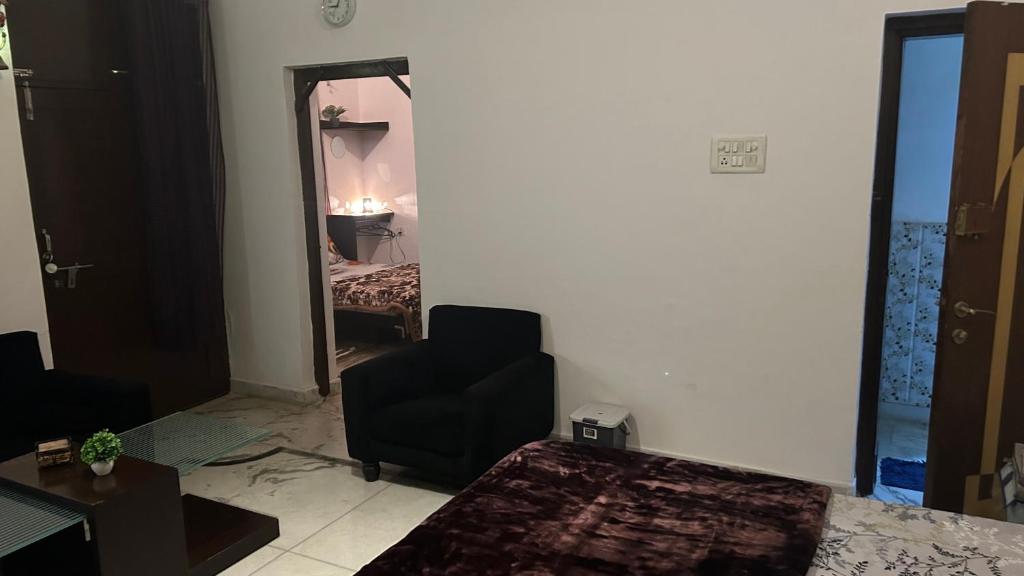 een woonkamer met een stoel en een spiegel bij Stay with Abhishek in Gwalior