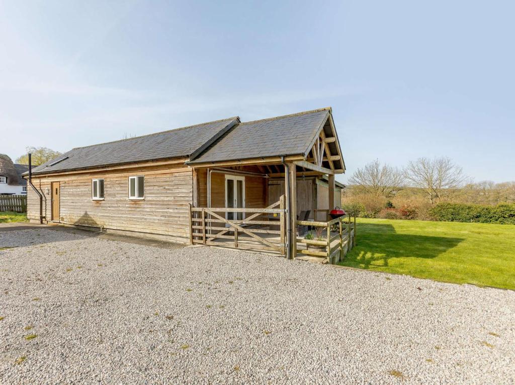a large wooden cabin with a gambrel roof at 2 Bed in Barnstaple 09089 in Umberleigh Bridge