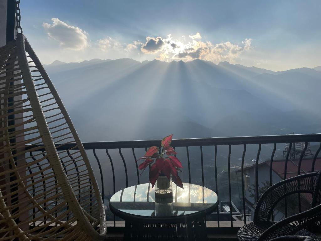 a table and chairs on a balcony with a view of a mountain at Liberty Sapa Hotel in Sapa
