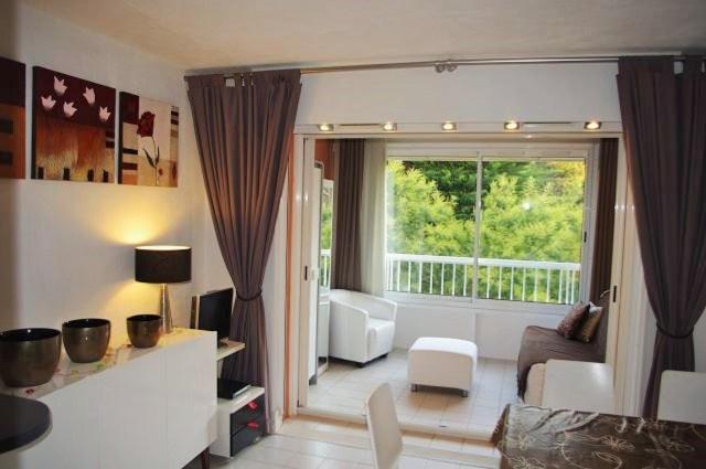 a living room with a large window and a couch at 150 m plage, domaine privé avec piscine in Six-Fours-les-Plages