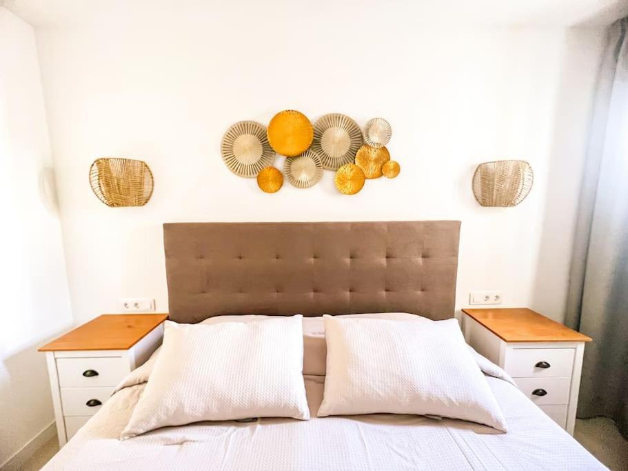 a bedroom with a bed with fruit on the wall at Stunning Bungalow Tropicana in Adeje