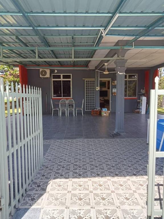 a patio with a white fence and a building at Mariah Homestay @ Station 18 in Ipoh