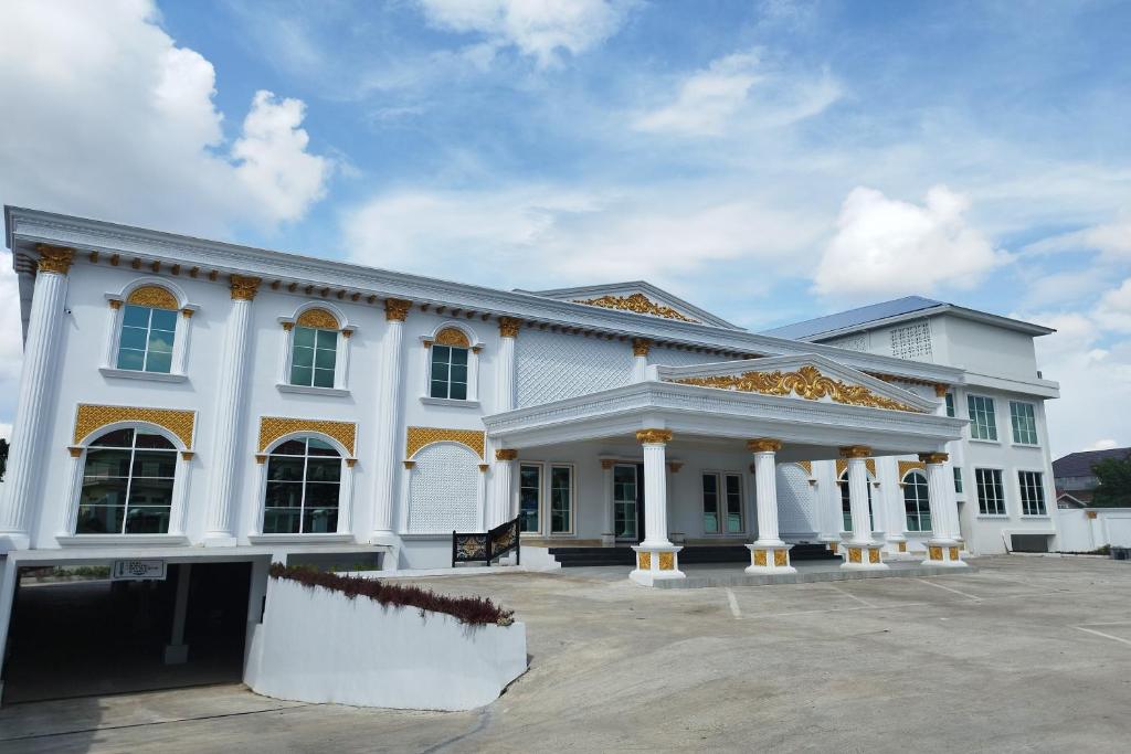 a large white building with a lot of windows at Maulidia Hotel & Convention Center in Jambi
