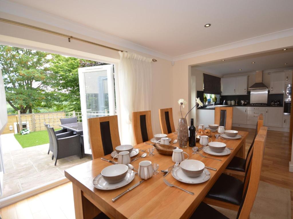 a wooden table with chairs and a dining room at 4 Bed in Bideford NILGA in Bideford