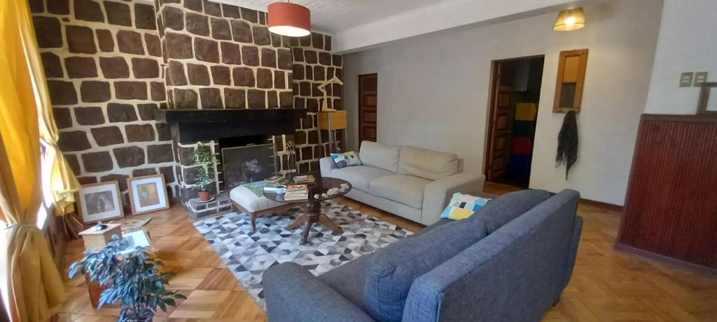 a living room with a couch and a fireplace at Terrandino in San José de Maipo