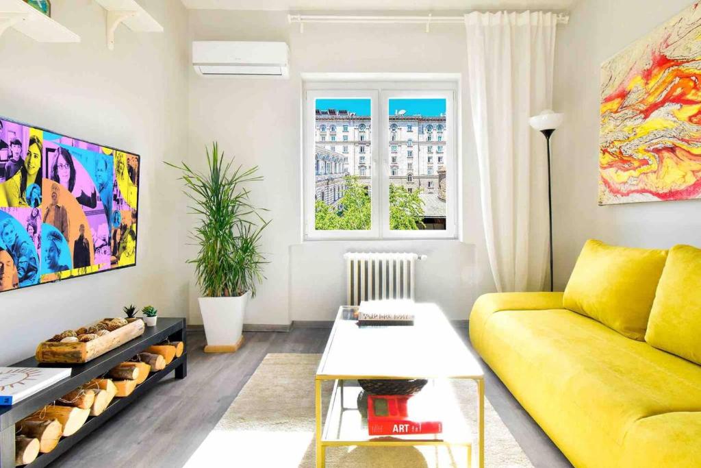 a living room with a yellow couch and a table at 1bd Presidential Neighbor Retreat, Ac, Kitchen in Sofia