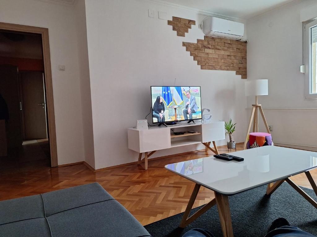 a living room with a tv and a table at Temple saint sava in Dušanovac (historical)