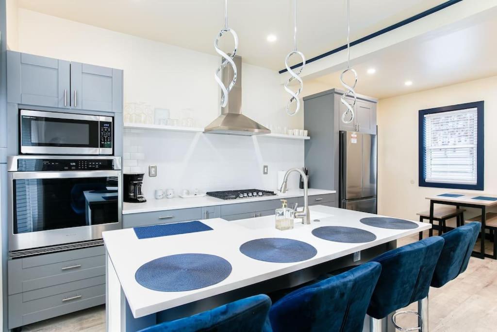 cocina con encimera blanca y sillas azules en Walk to ND, Hot Tub, Lux Kitchen, Pet Friendly, en South Bend