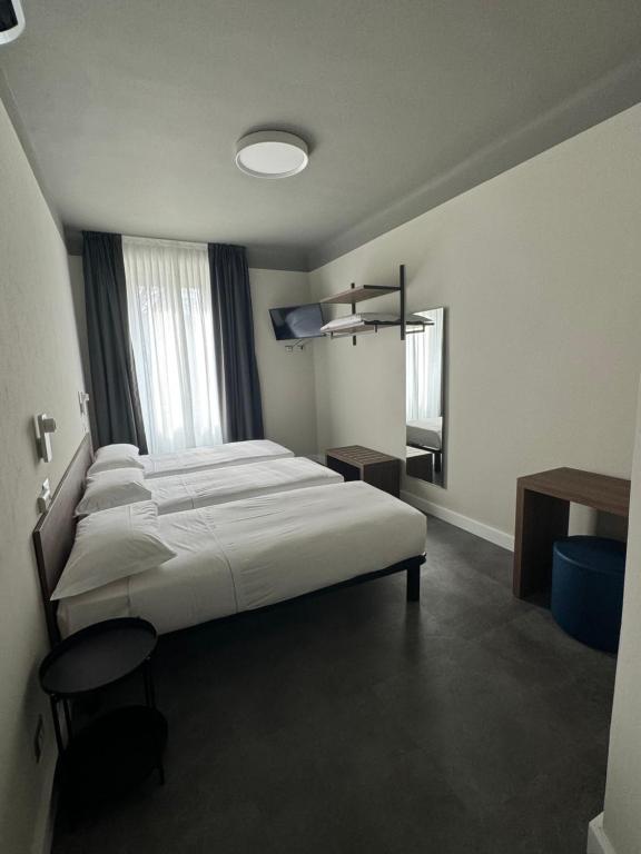 Postel nebo postele na pokoji v ubytování Hotel 22 Marzo