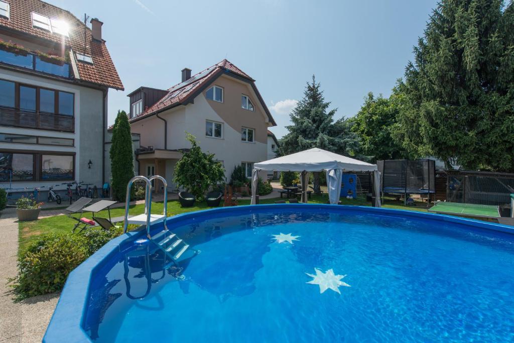 a swimming pool in the backyard of a house at Pension Haus Sanz in Vienna