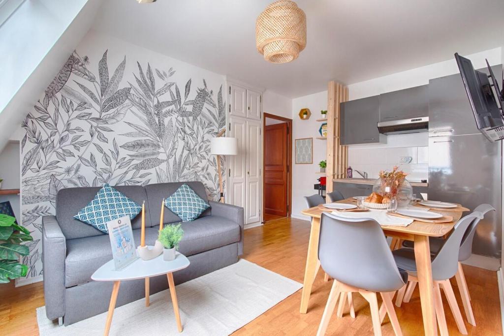 a living room with a couch and a table at Appartement near to Saint Lazare - 6P in Paris