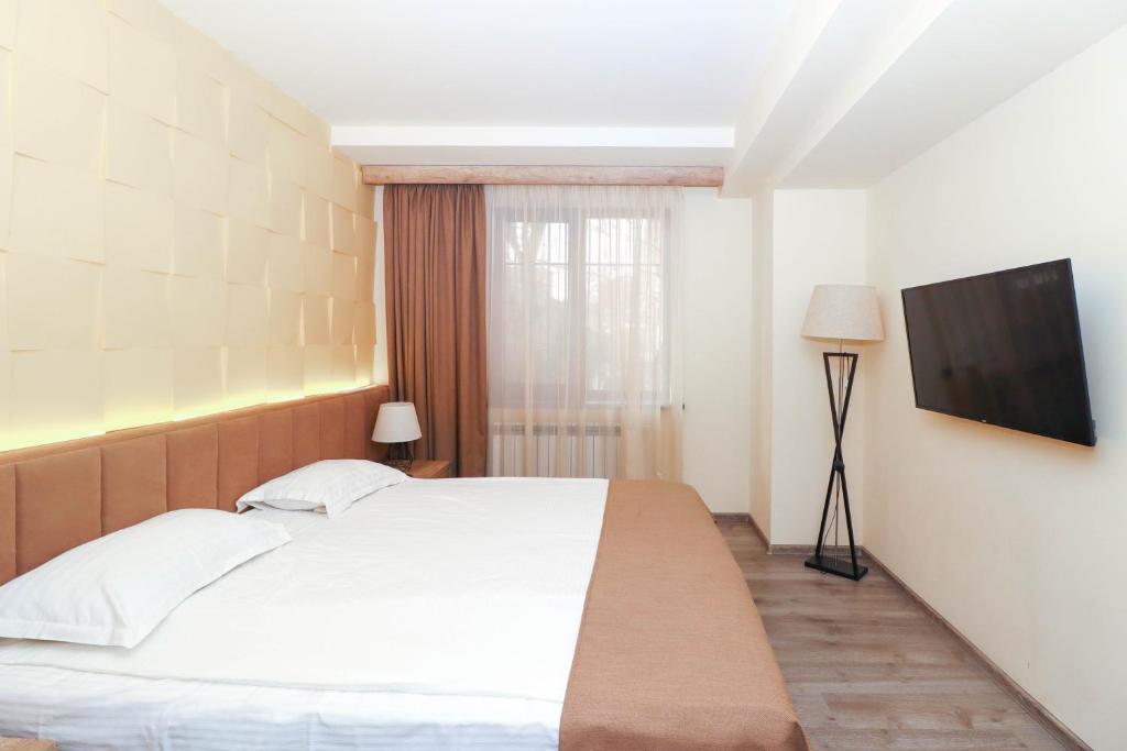 Postel nebo postele na pokoji v ubytování MANDARIN Hotel