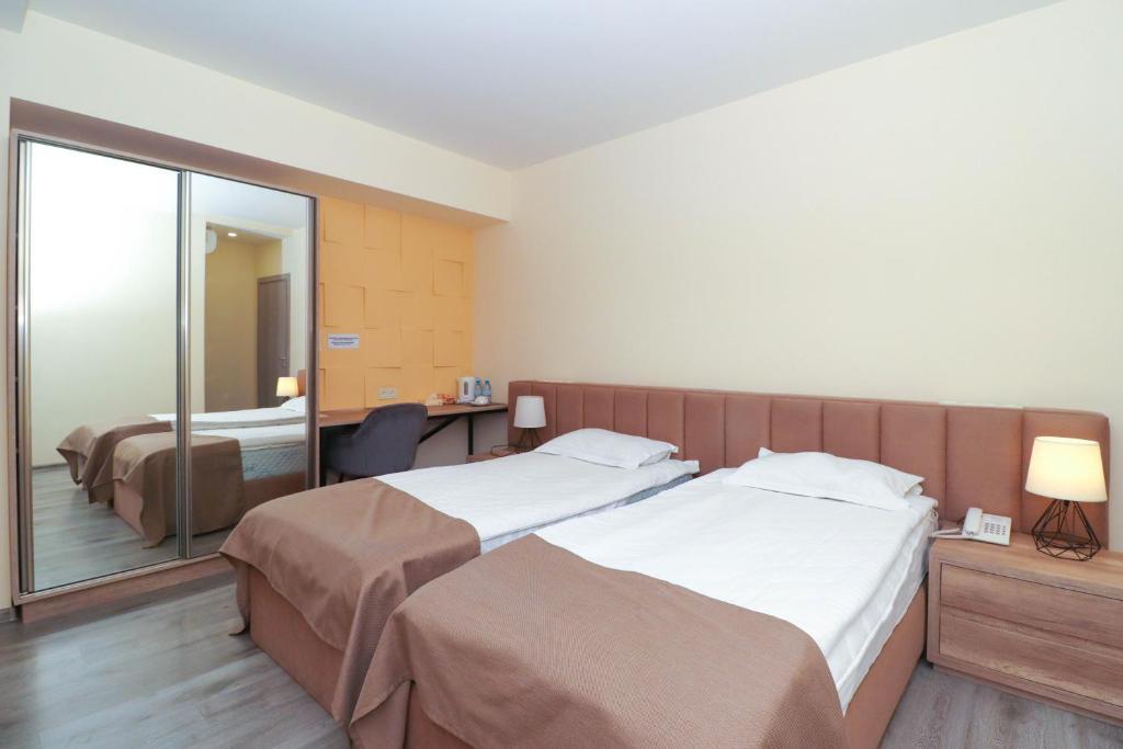 Postel nebo postele na pokoji v ubytování MANDARIN Hotel