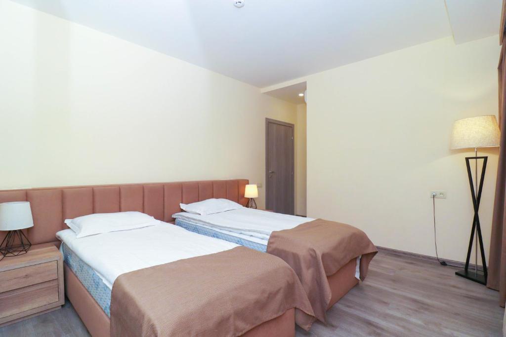 Postel nebo postele na pokoji v ubytování MANDARIN Hotel