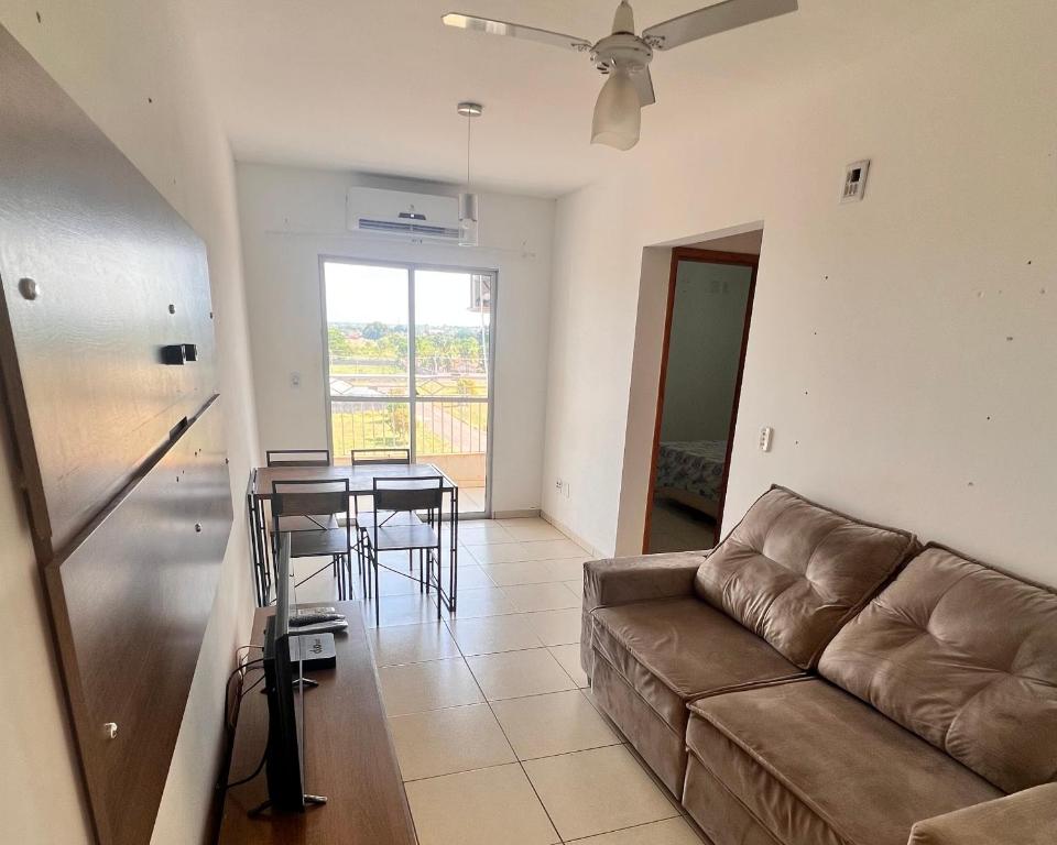 a living room with a couch and a table at Apartamento 2 quartos mobiliado in Três Lagoas