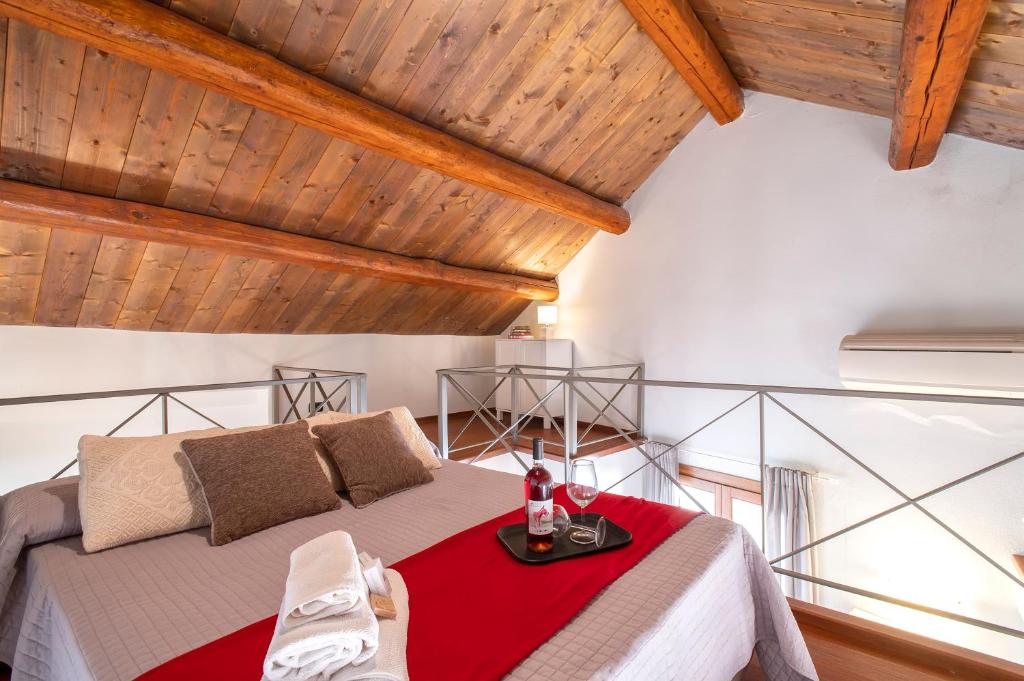 a bedroom with a bed with a red blanket at Sa Domo Apartments in Alghero