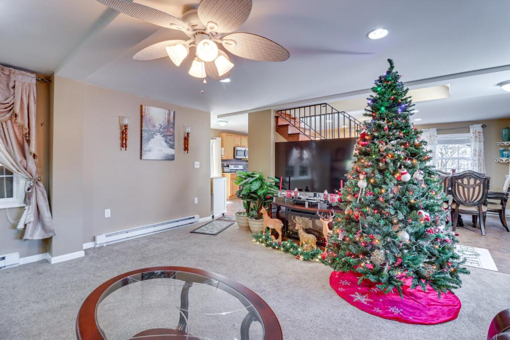 a christmas tree in the middle of a living room at Riverfront Kresgeville Getaway Near Blue Mountain! 