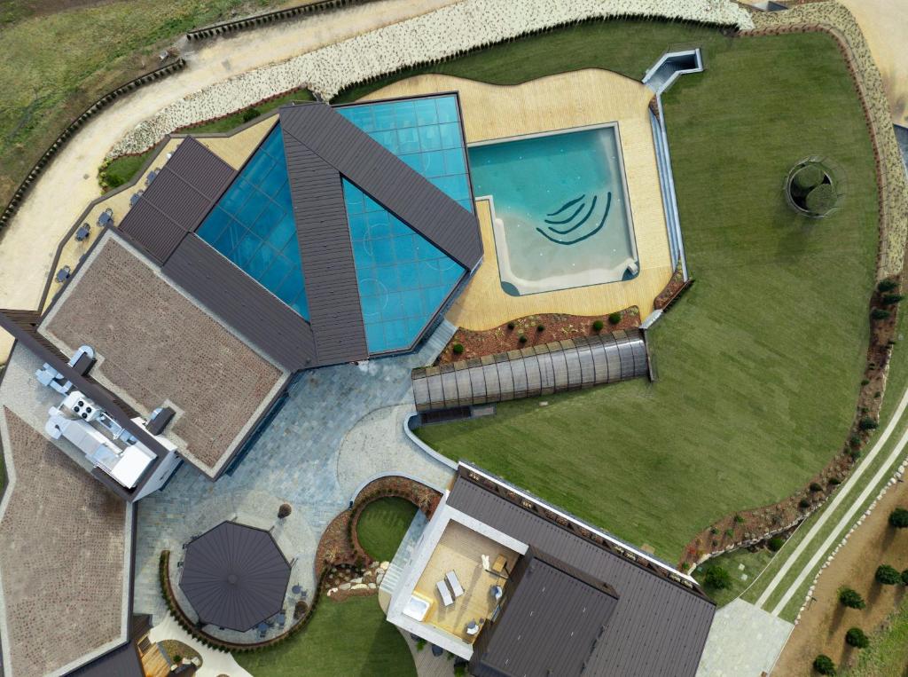 an overhead view of a house with a swimming pool at Collina Luxury Relais in Clusone