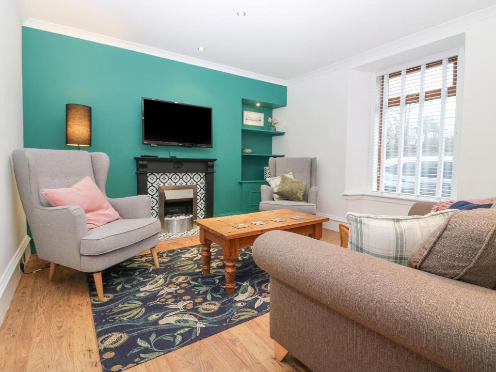 a living room with a couch and a fireplace at 16 Main Street in Ellon