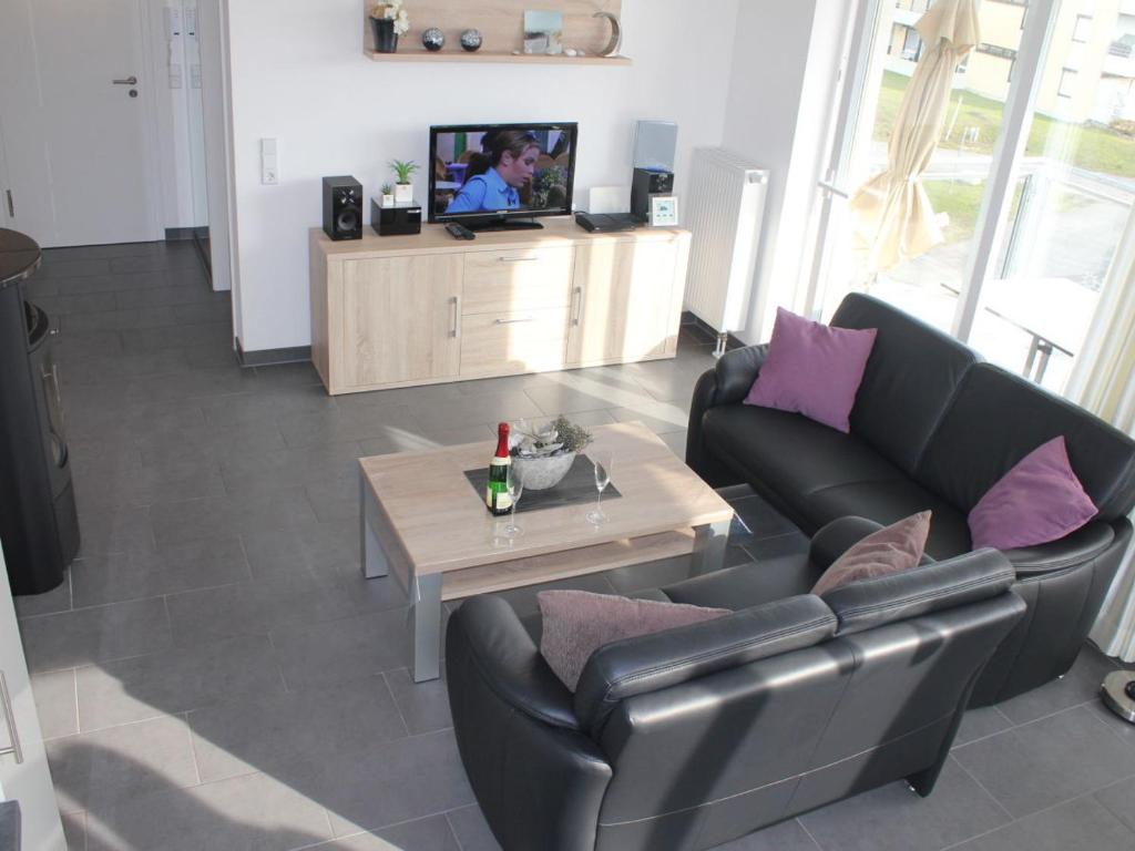 a living room with a couch and a table at Leuchtturm 10 in Großenbrode