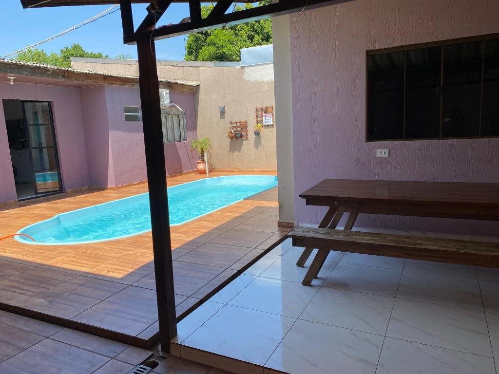 a view of a swimming pool from the patio of a house at Casa c/ piscina e edícula in Foz do Iguaçu