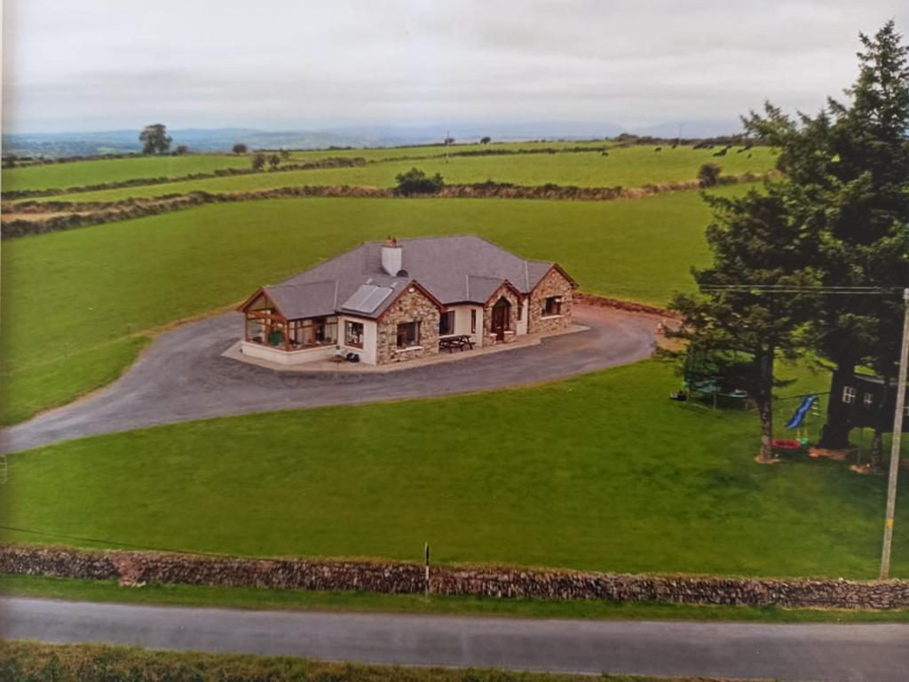 an aerial view of a house in a green field at Four Seasons in Waterford