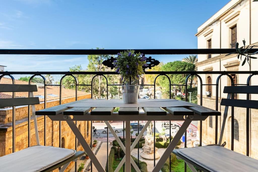 a table on a balcony with two chairs at Agrigento Luxury Suite Kandinskij in Agrigento