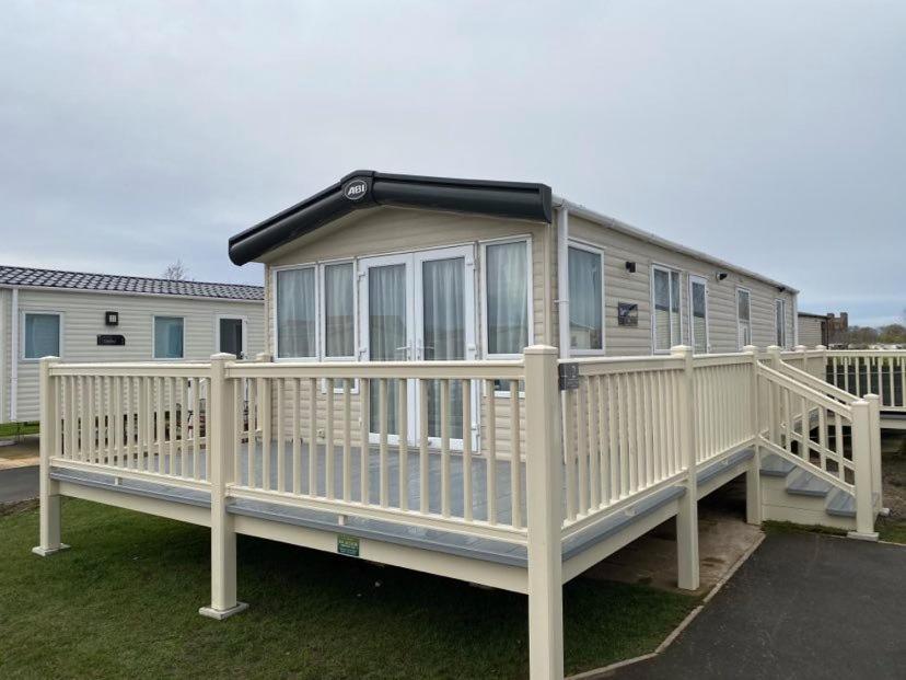 a large white house with a large deck at KINGFISHER COURT 2 Tattershall lakes with hot tub in Tattershall