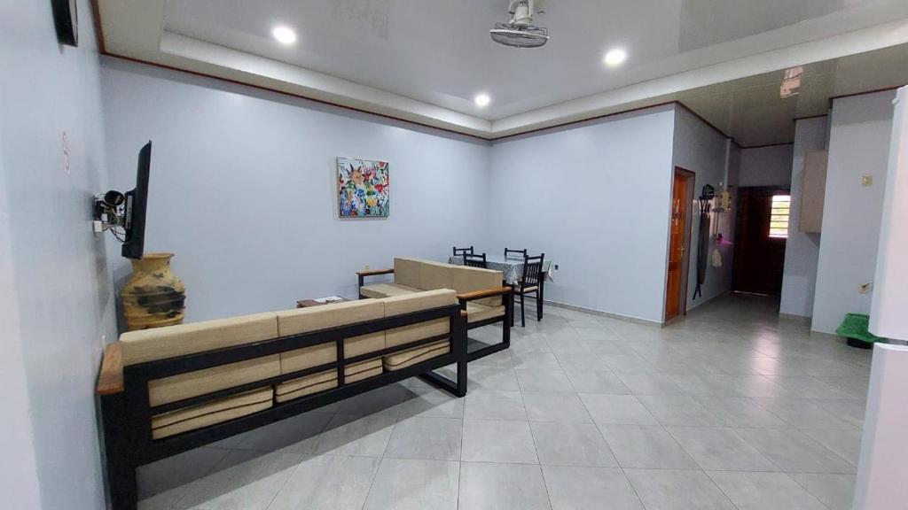 a waiting room with benches and a white wall at V3 appartement in Paramaribo