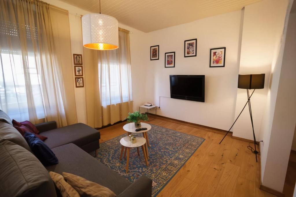 a living room with a couch and a tv at Moselzauber Güls in Koblenz