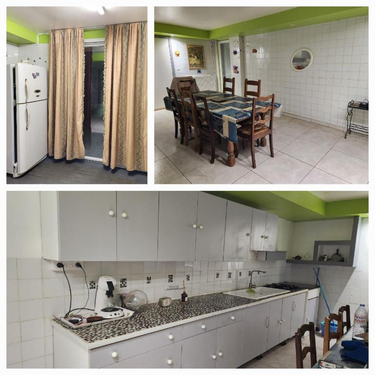 Il comprend une cuisine équipée d'un réfrigérateur blanc et d'une table avec des chaises. dans l'établissement Maison de vacances, à Saint-Amour