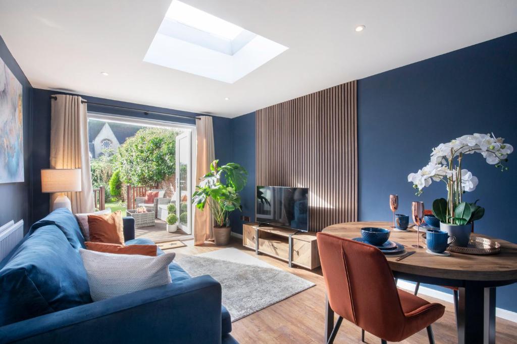 a living room with blue walls and a blue couch at Pittville Circus Road in Cheltenham