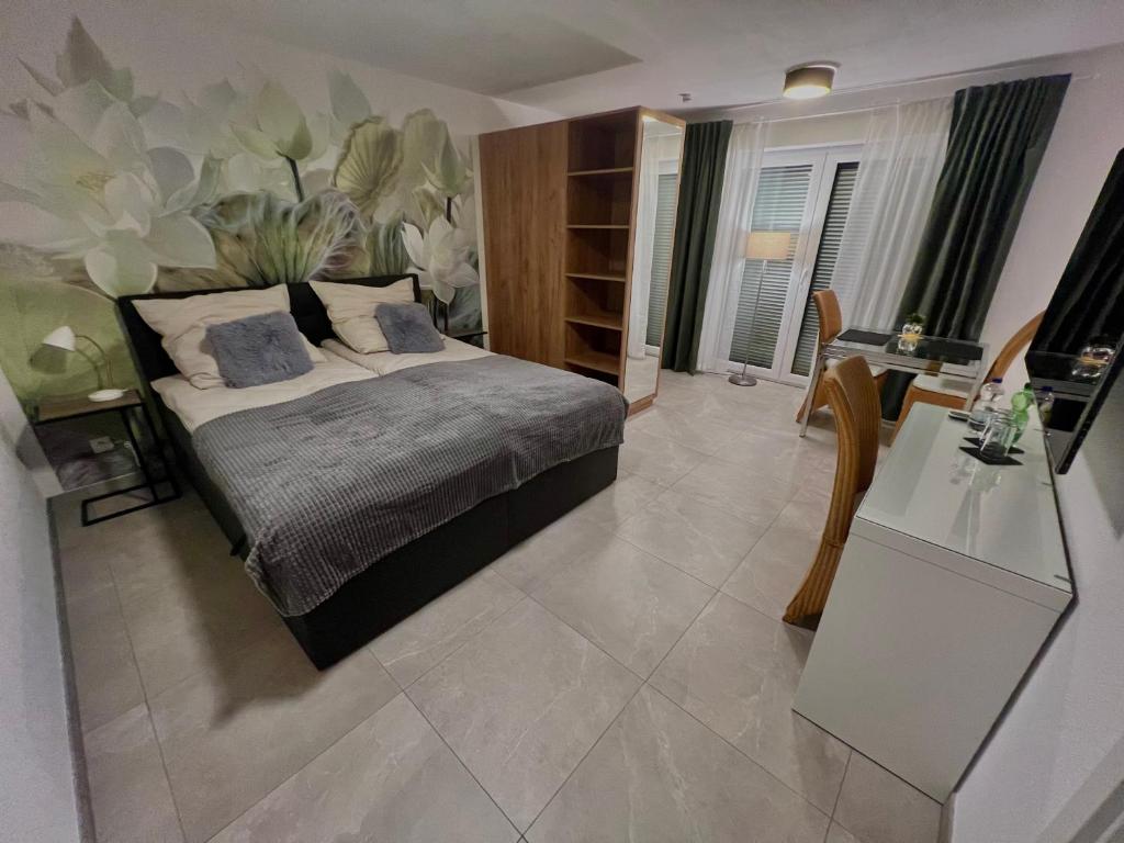a bedroom with a bed and a desk in it at Ferienwohnung im Odenwald in Limbach