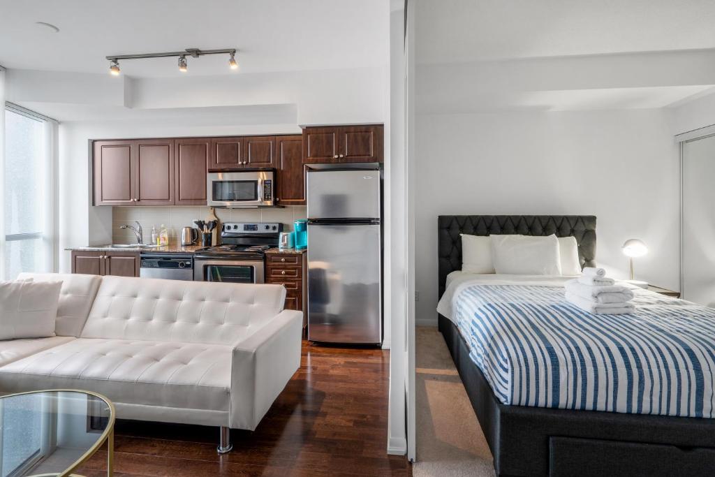 a living room with a bed and a kitchen at DownTown Toronto luxury condo in Toronto