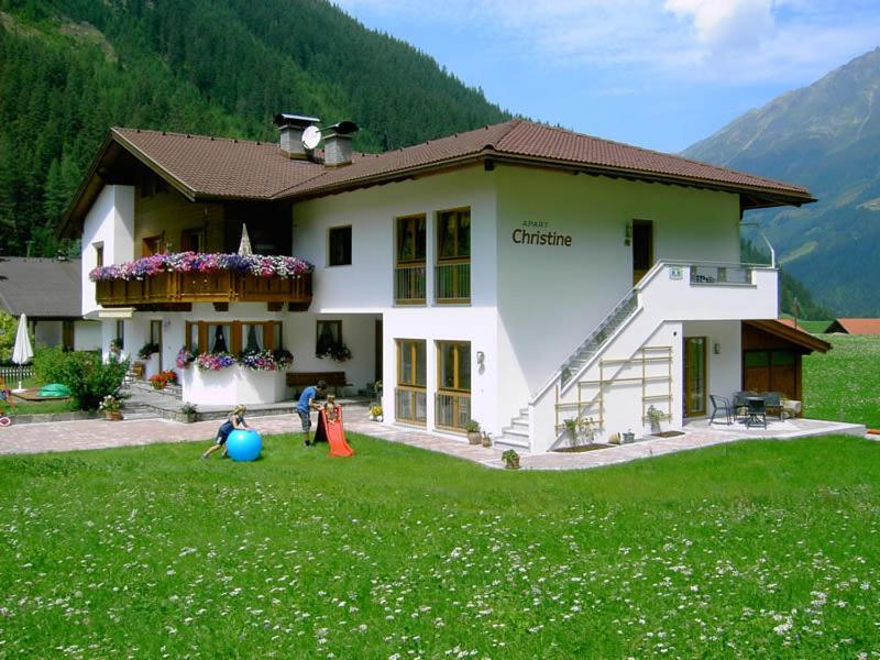 a group of children playing outside of a house at Apart Christine in Kaunertal