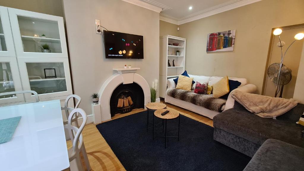a living room with a couch and a fireplace at Stylish 2 Bedroom Apartment, Leeds Centre + Free Parking in Leeds