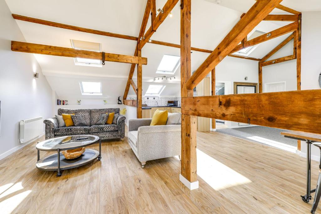 a living room with a couch and a table at The Old Warehouse Ely "Apartments" in Ely