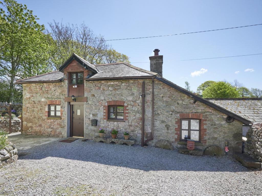 a stone house with a driveway in front of it at 1 Bed in Eskdale SZ471 in Beckfoot