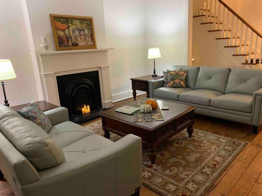 a living room with two couches and a fireplace at Madison Manor II by the River Hot Tub Downtown in Madison