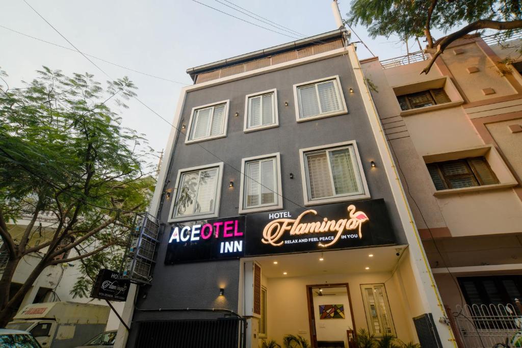een gebouw met een bord aan de zijkant bij Aceotel Inn Flamingo Vijay Nagar in Indore