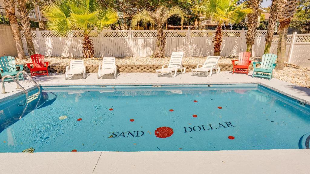 a swimming pool with chairs and a sign that reads sand dollar at Sand Dollar - 3rd Row - Ocean Drive Section in Myrtle Beach