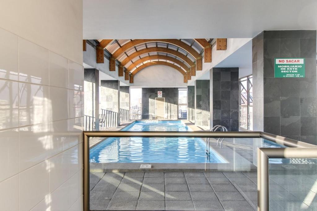a large swimming pool in a building at Alcantara'S Merced 562 in Santiago