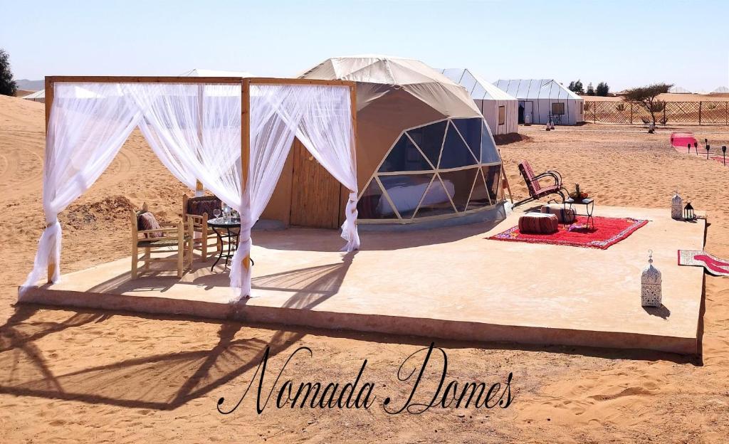 a tent in the middle of the desert at Nomada Domes in Merzouga